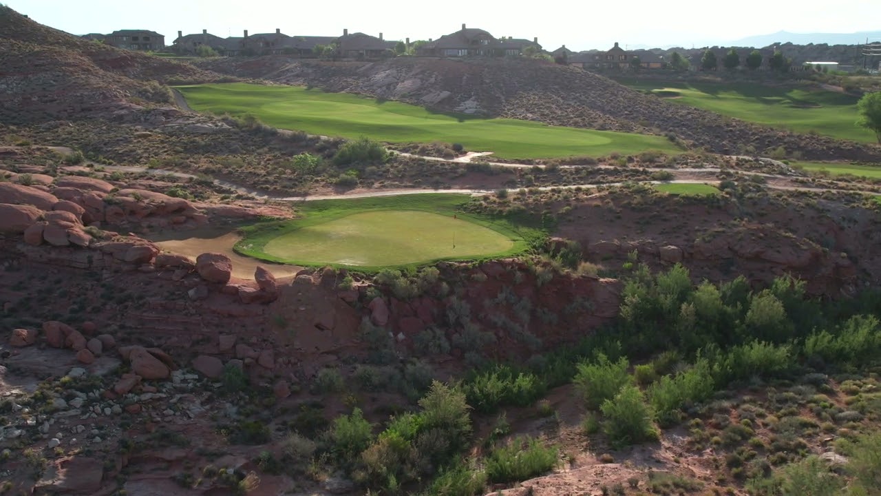 Coral Canyon Golf Course panoramic hole with desert vegetation and red rock canyon backdrop